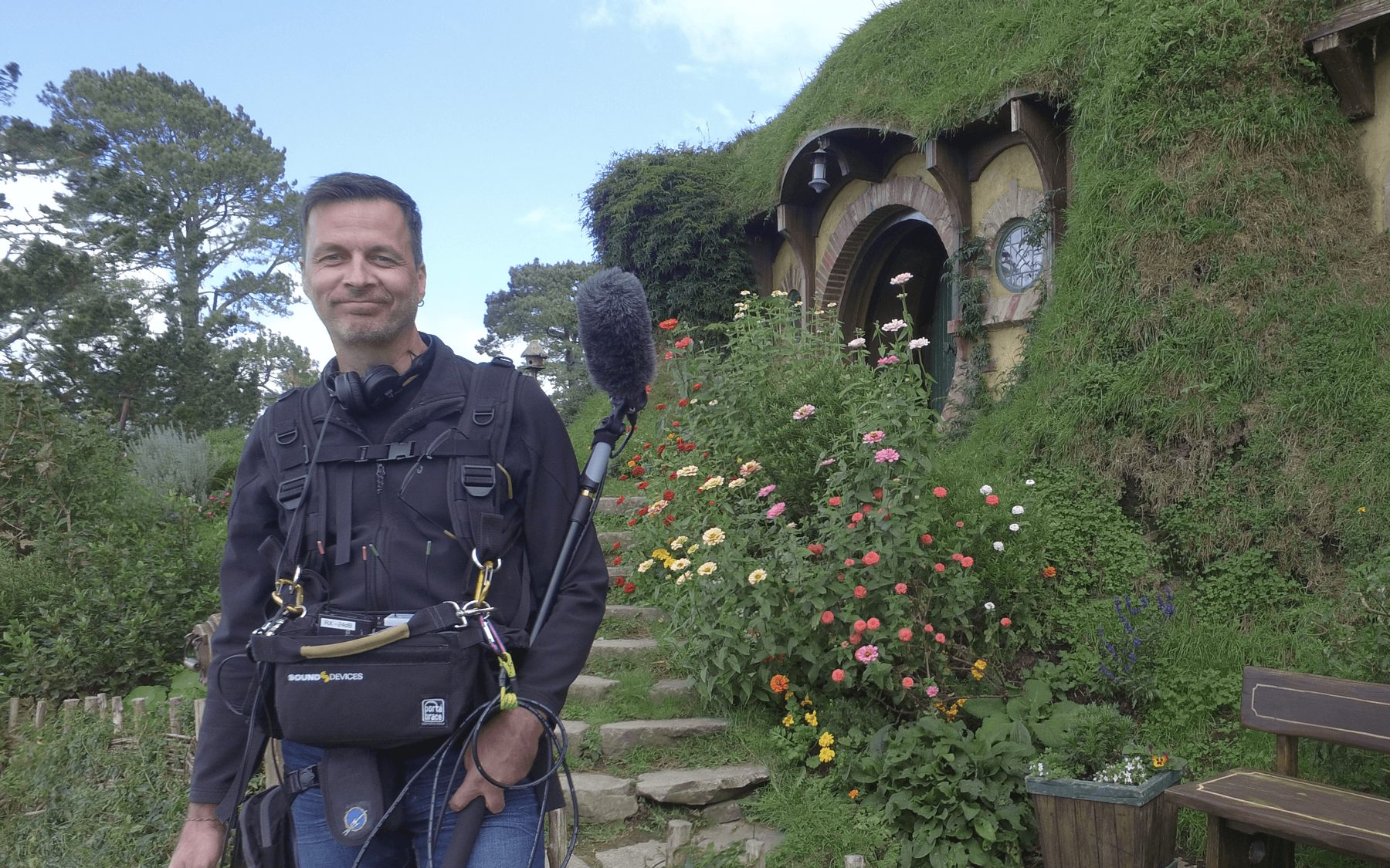 Sound recordist with boom microphone on location