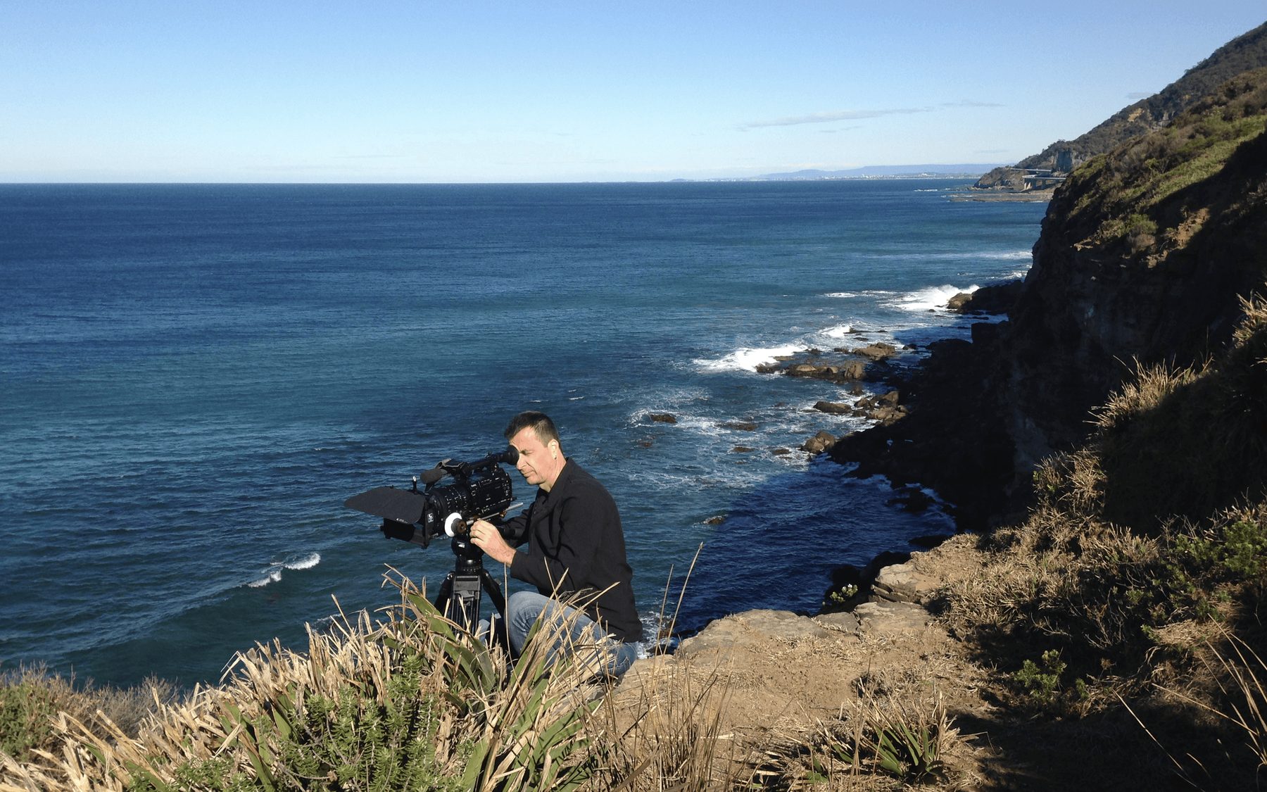 Cinema camera set up on a coastal cliff shoot