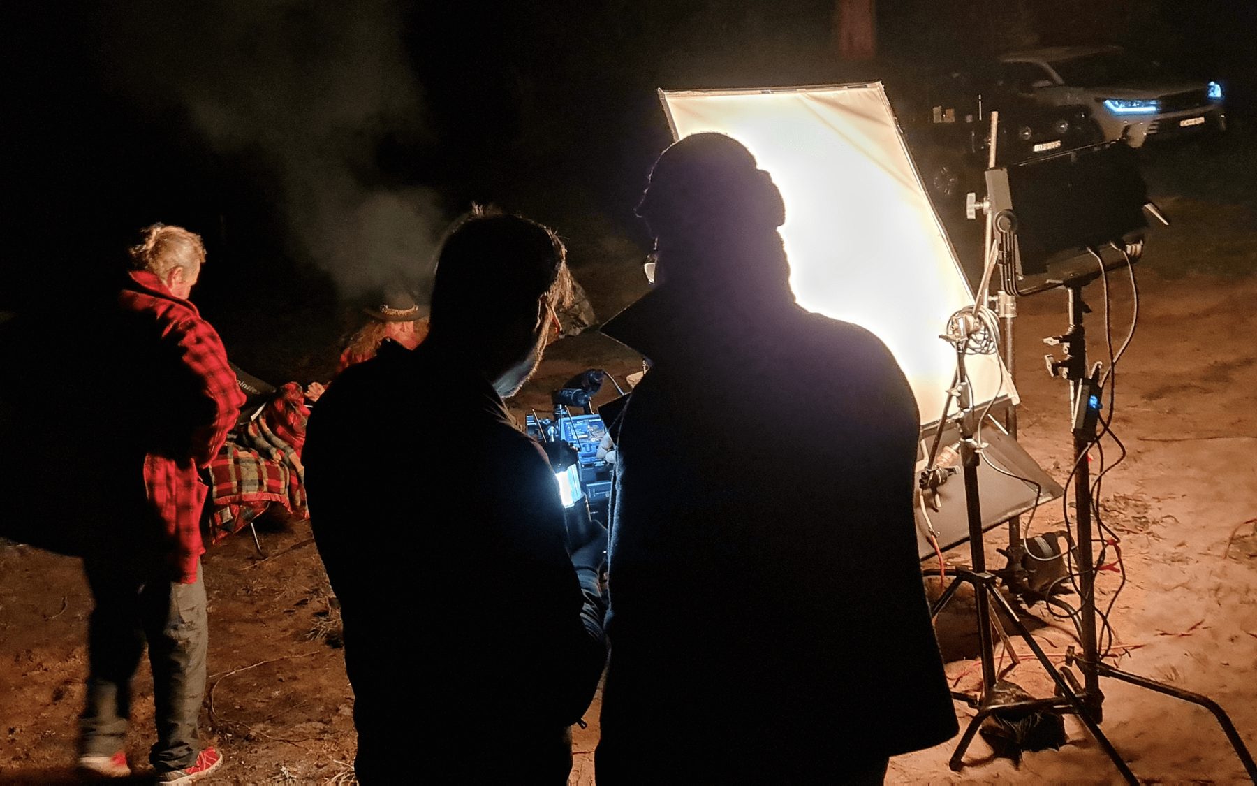 Night shoot with lighting rig and campfire