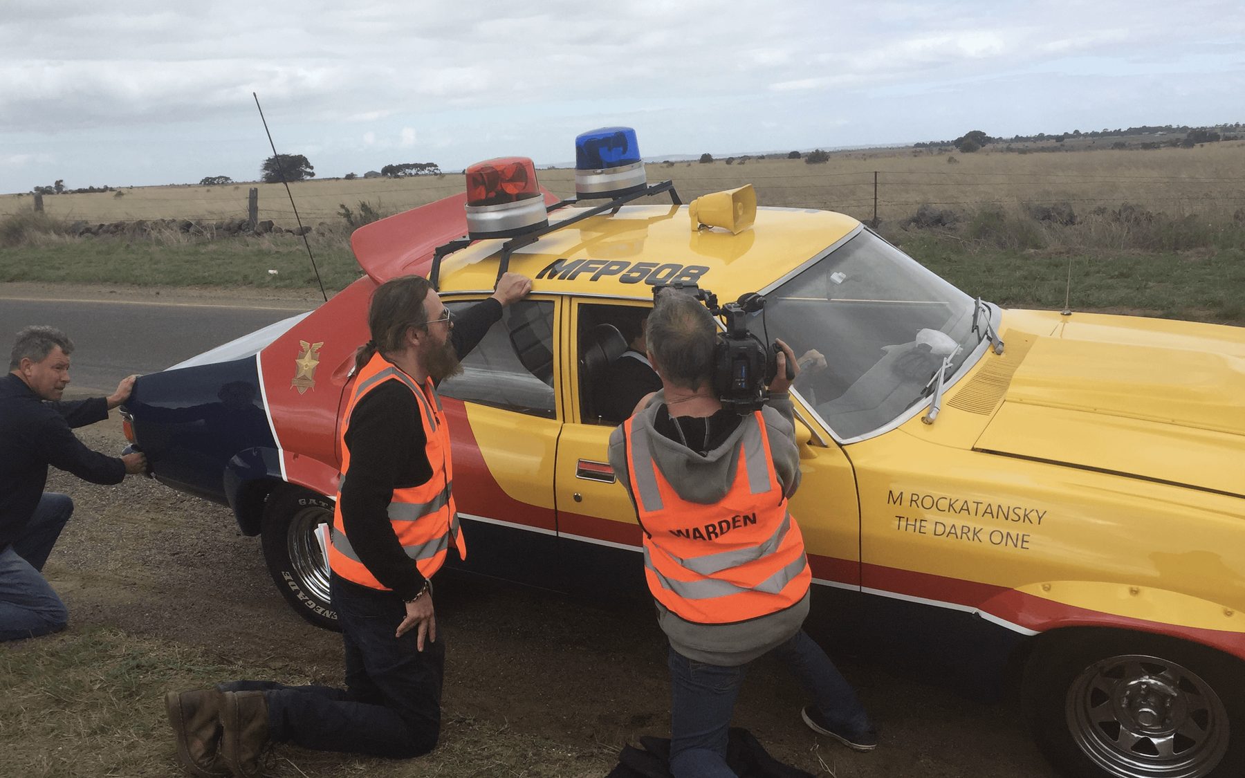 Crew rigging a pursuit vehicle for an outback shoot