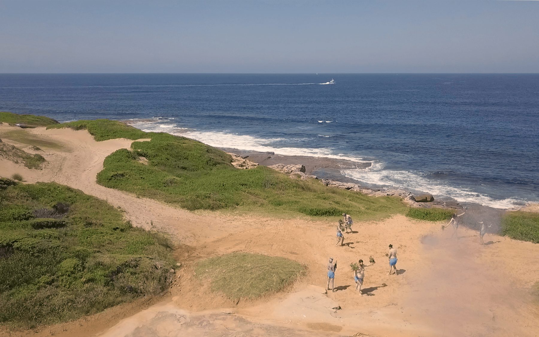 Aerial view of ceremony dancers on coastal dunes for the AHMRC campaign