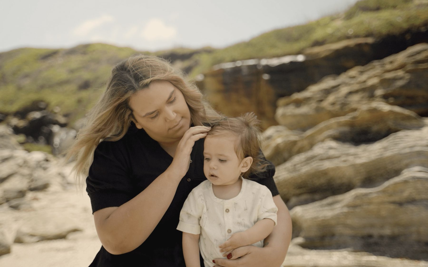 Portrait of a mother and child on the coastline for the AHMRC campaign