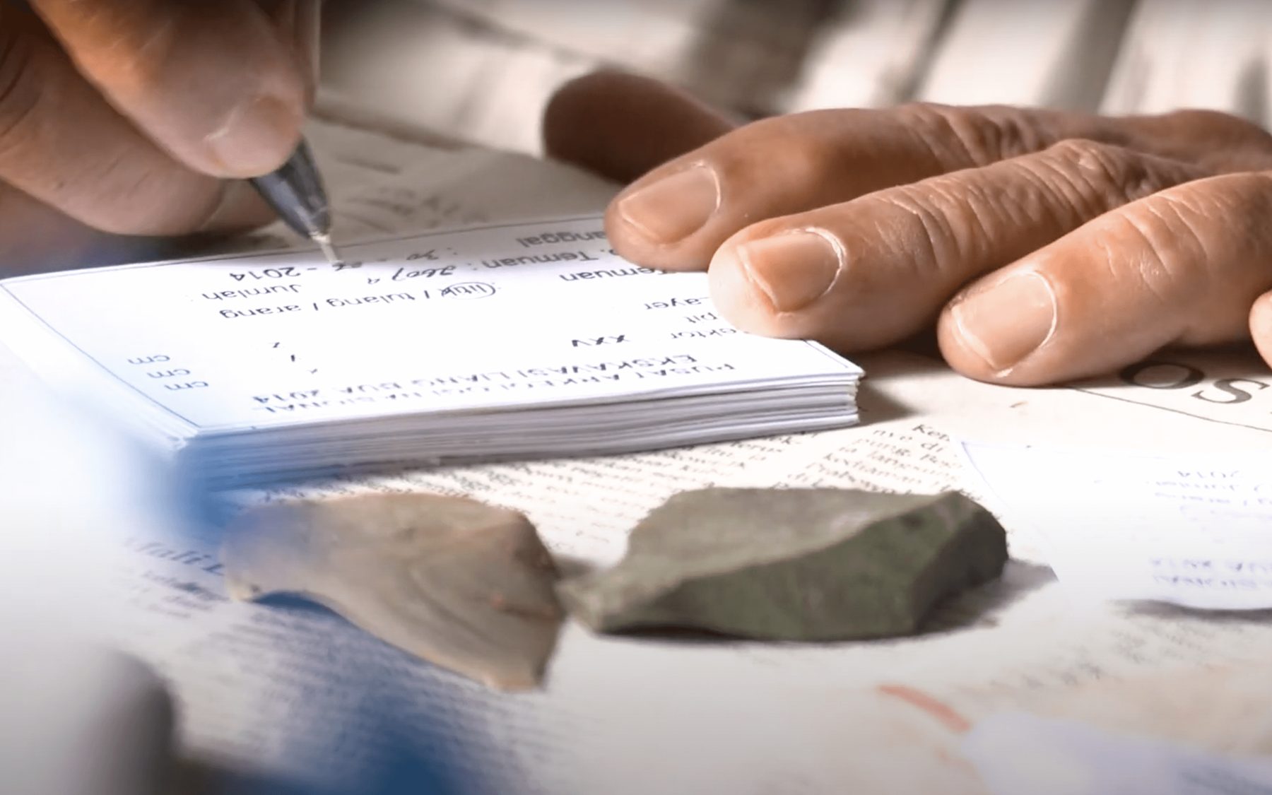 Close-up of an archaeological artefact being logged and recorded