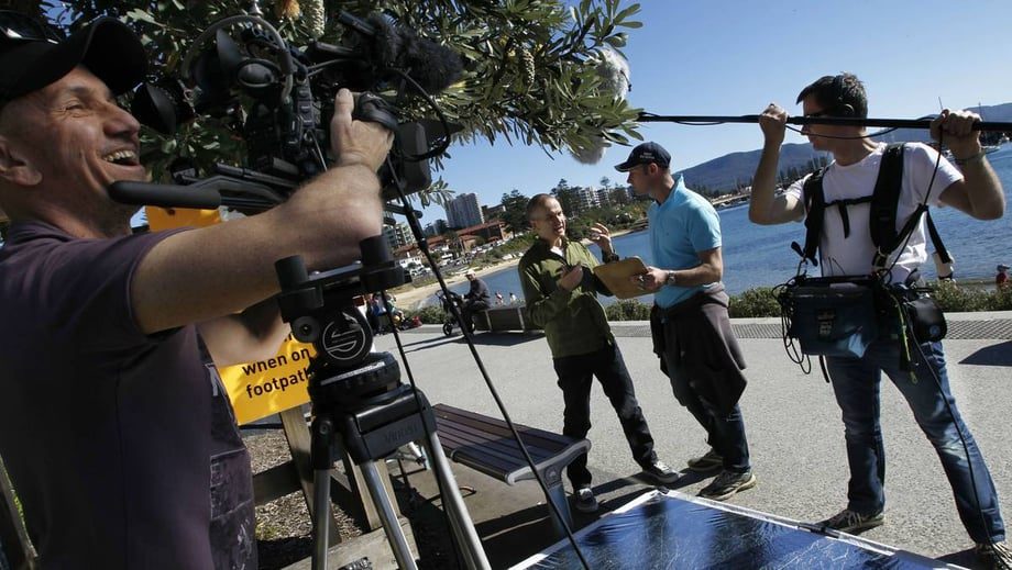 Camera crew filming a research interview on location, producing a video abstract for academic research communication