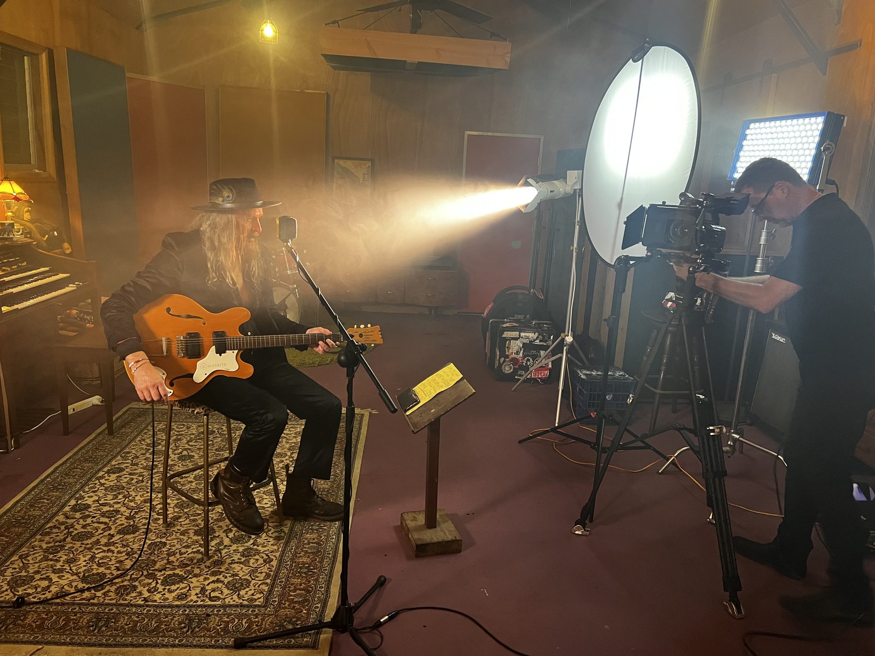 Perigon Media crew filming a musician in the studio - behind the scenes of a professional video production partnership