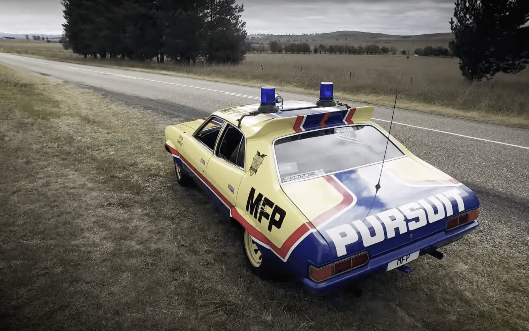 Rear view of a hand-built MFP pursuit vehicle on a rural road
