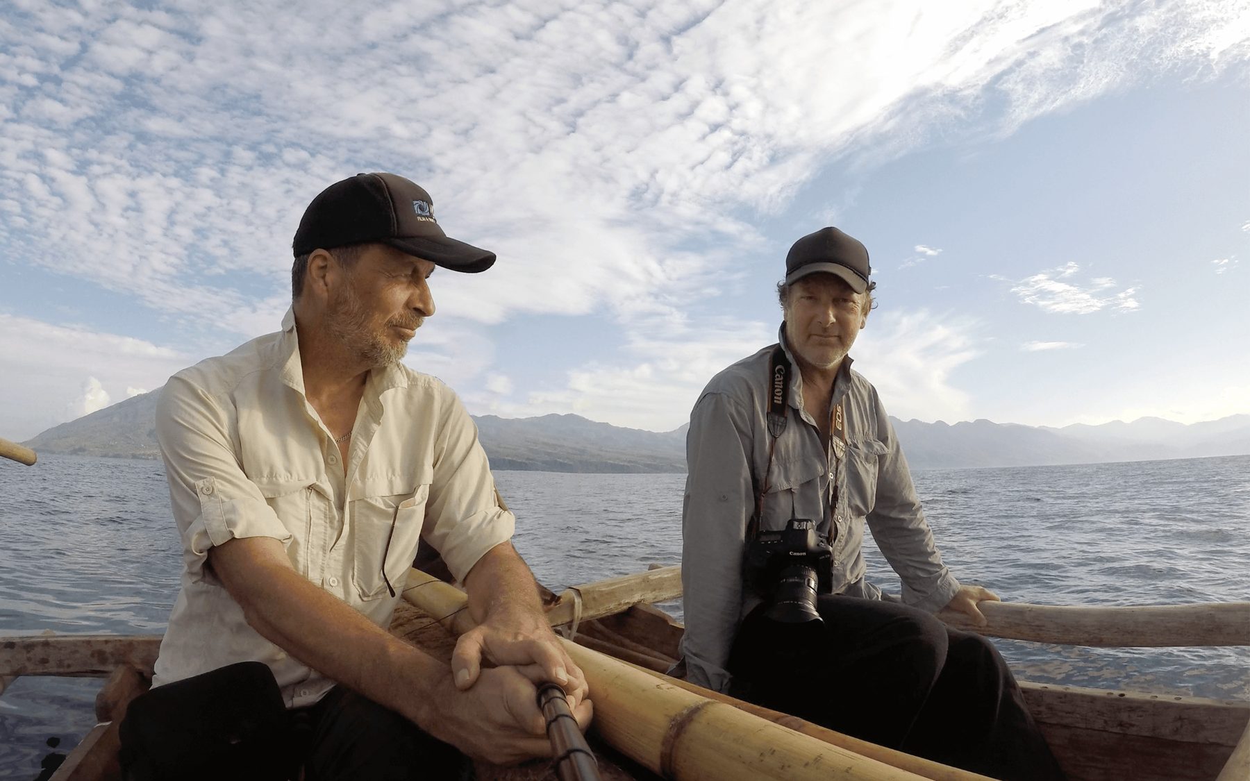 Camera crew filming from a small boat on the water